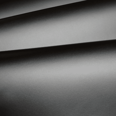 Close-up of smooth black leather surface with fine texture, premium full-grain material for luxury leather goods and craftsmanship