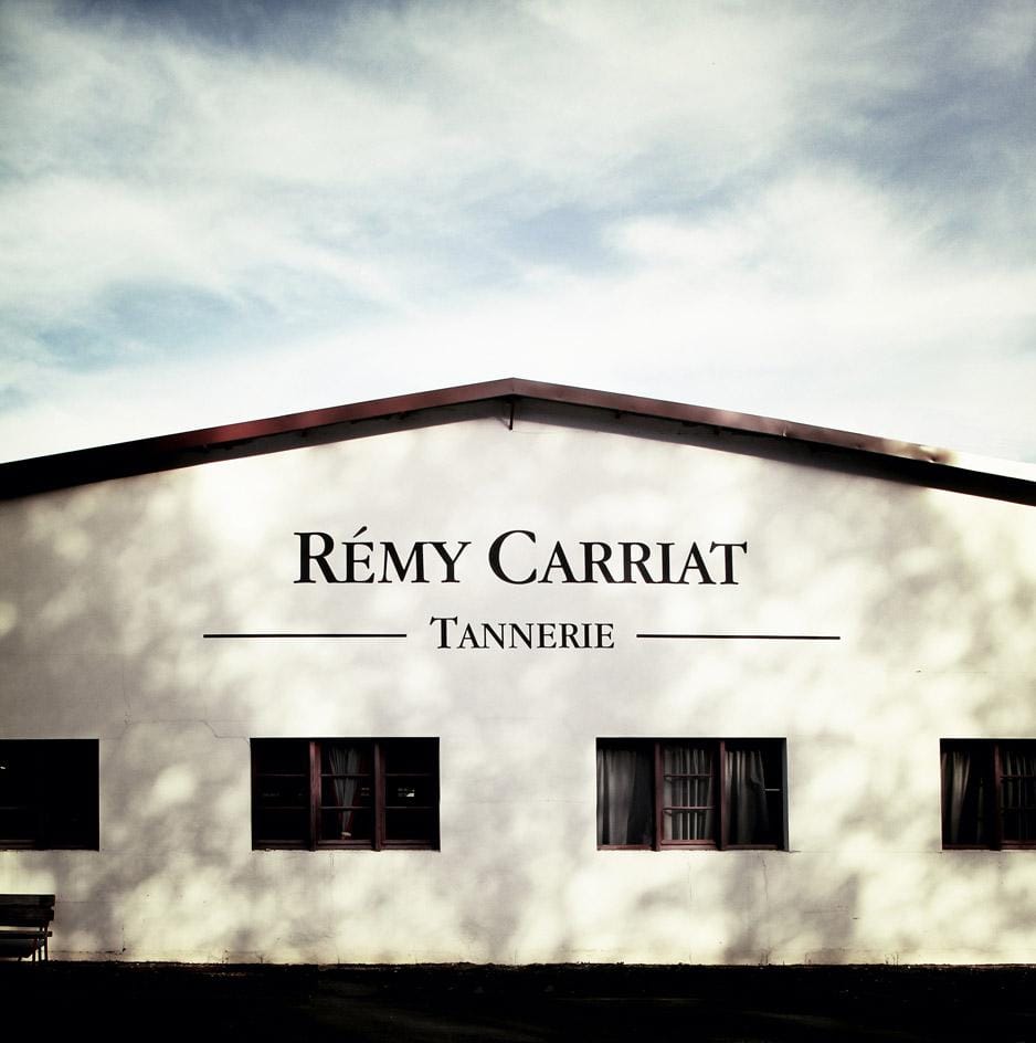 Facade of Tanneries Rémy Carriat building in Espelette, France, known for producing premium taurillon leather.